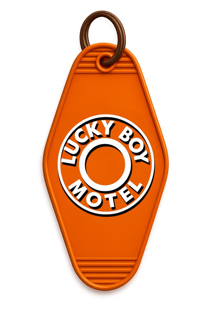Orange Lucky Boy Motel key tag with metal ring.
